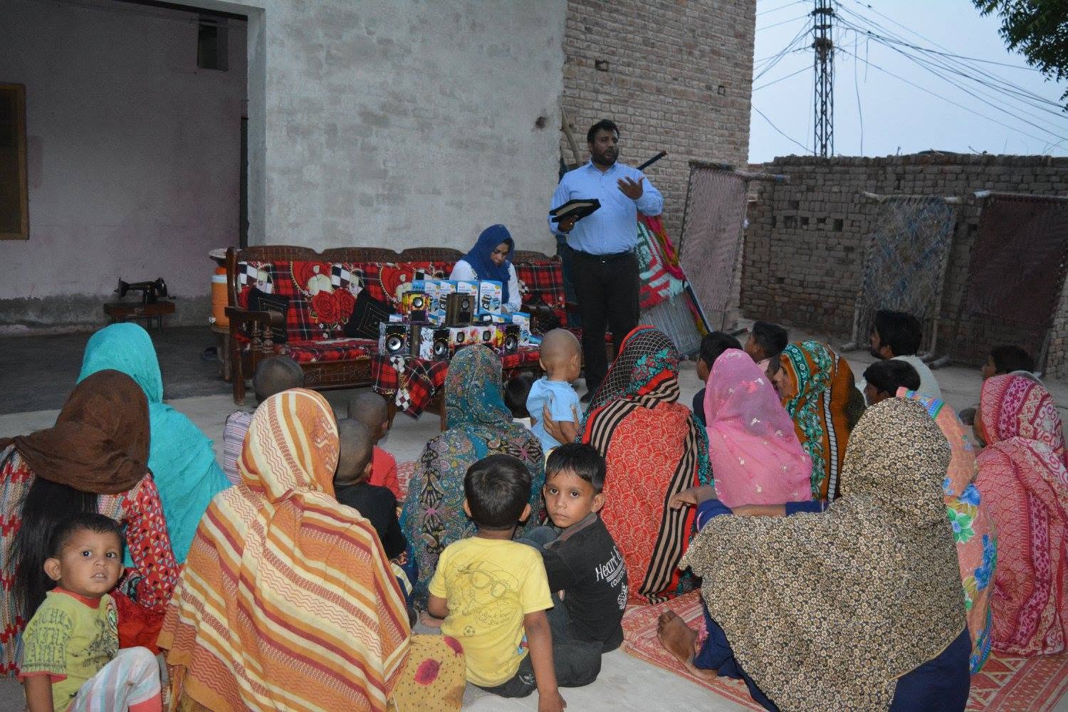 Grace Charity School staff meeting with families in a brick-kiln community