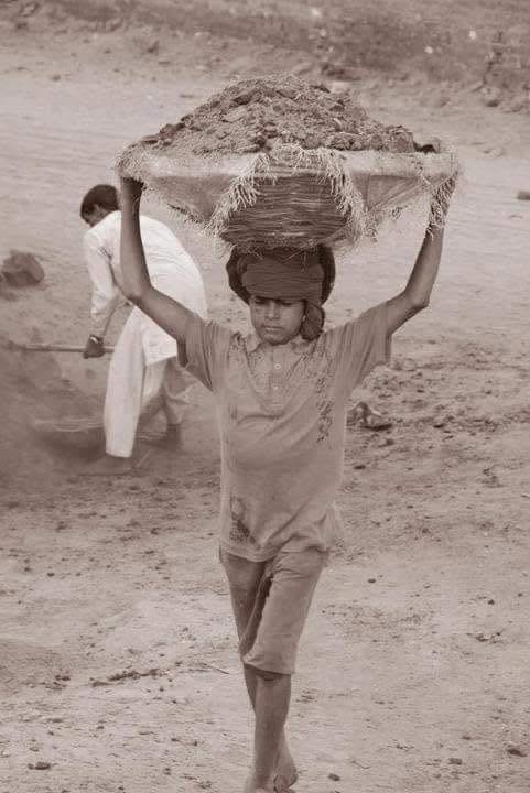 A child carrying bricks at a kiln in Pakistan