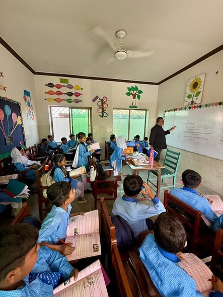 Students writing in a classroom at Grace Charity School