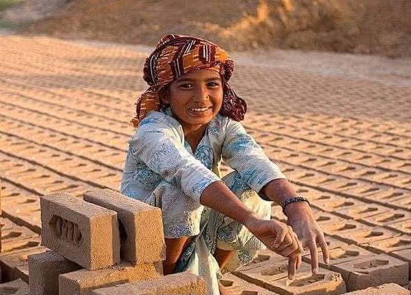A smiling girl at a brick kiln in Pakistan
